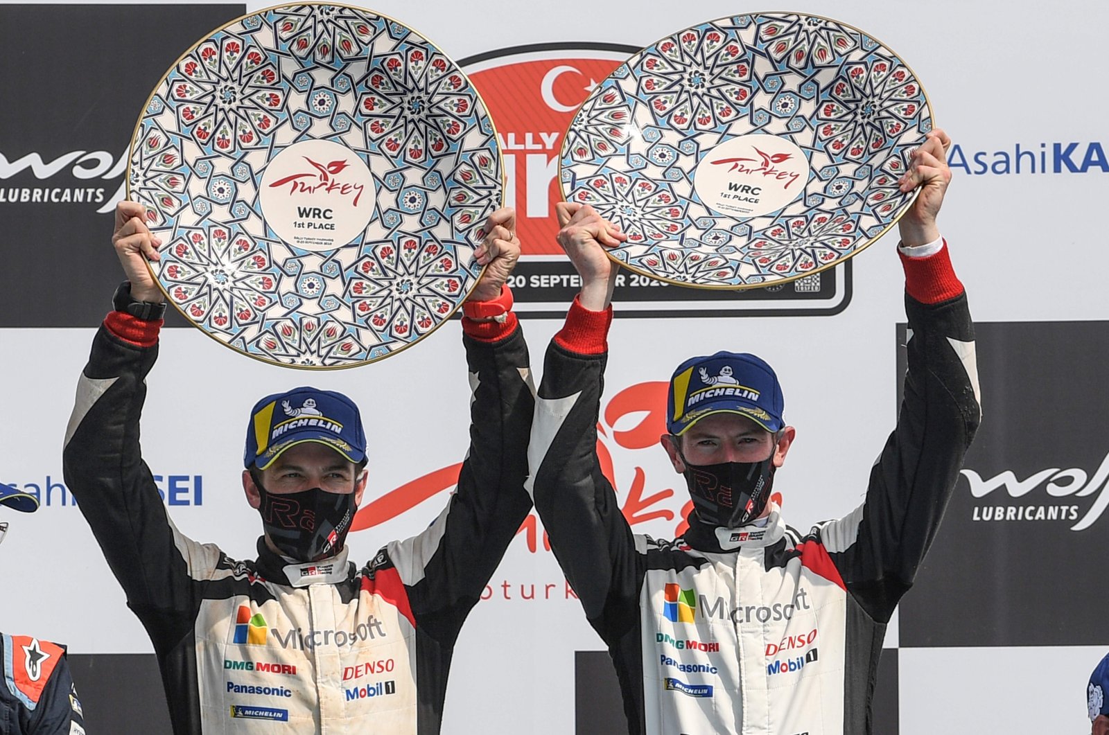 Elfyn Evans (R) and co-driver Scott Martin (L) celebrate their victory during the podium ceremony for the Turkish stage of the 2020 FIA World Rally Championship, in Muğla, Turkey, Sept. 20, 2020. (AFP Photo)