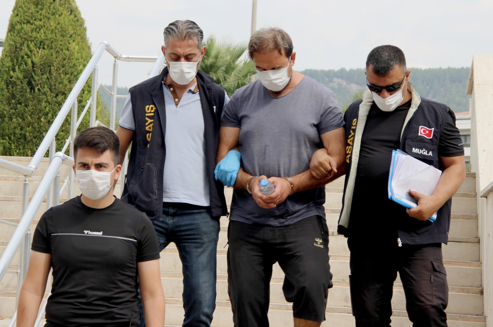 Police officers detain Tayfun Demir, (C) in Muğla, Turkey, Sept. 20, 2020. (IHA Photo)