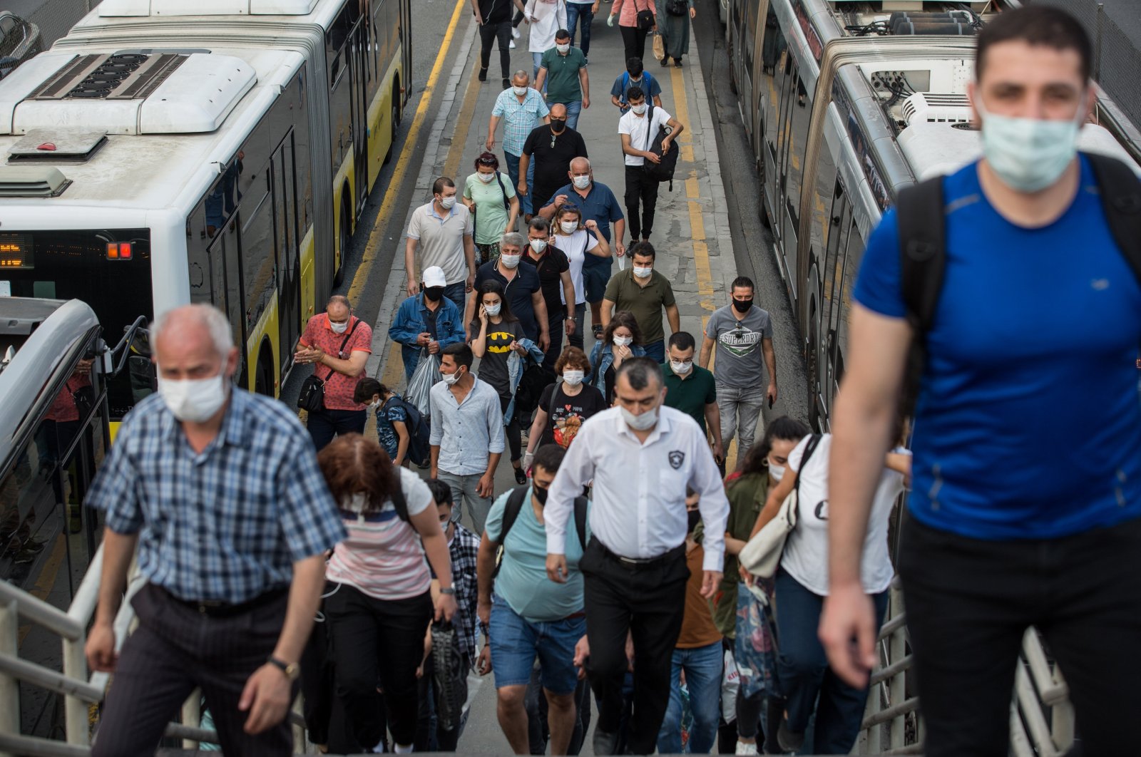 People wearing masks exit the Cevizlibağ Metrobus Station in Istanbul on June 23, 2020 (DHA File Photo)