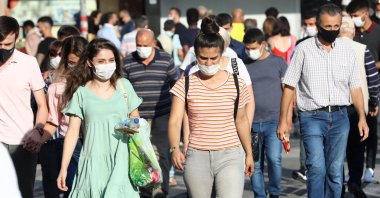 People wear protective face masks while walking along a street in the capital Ankara, Turkey, Sept. 18, 2020. (AFP Photo)