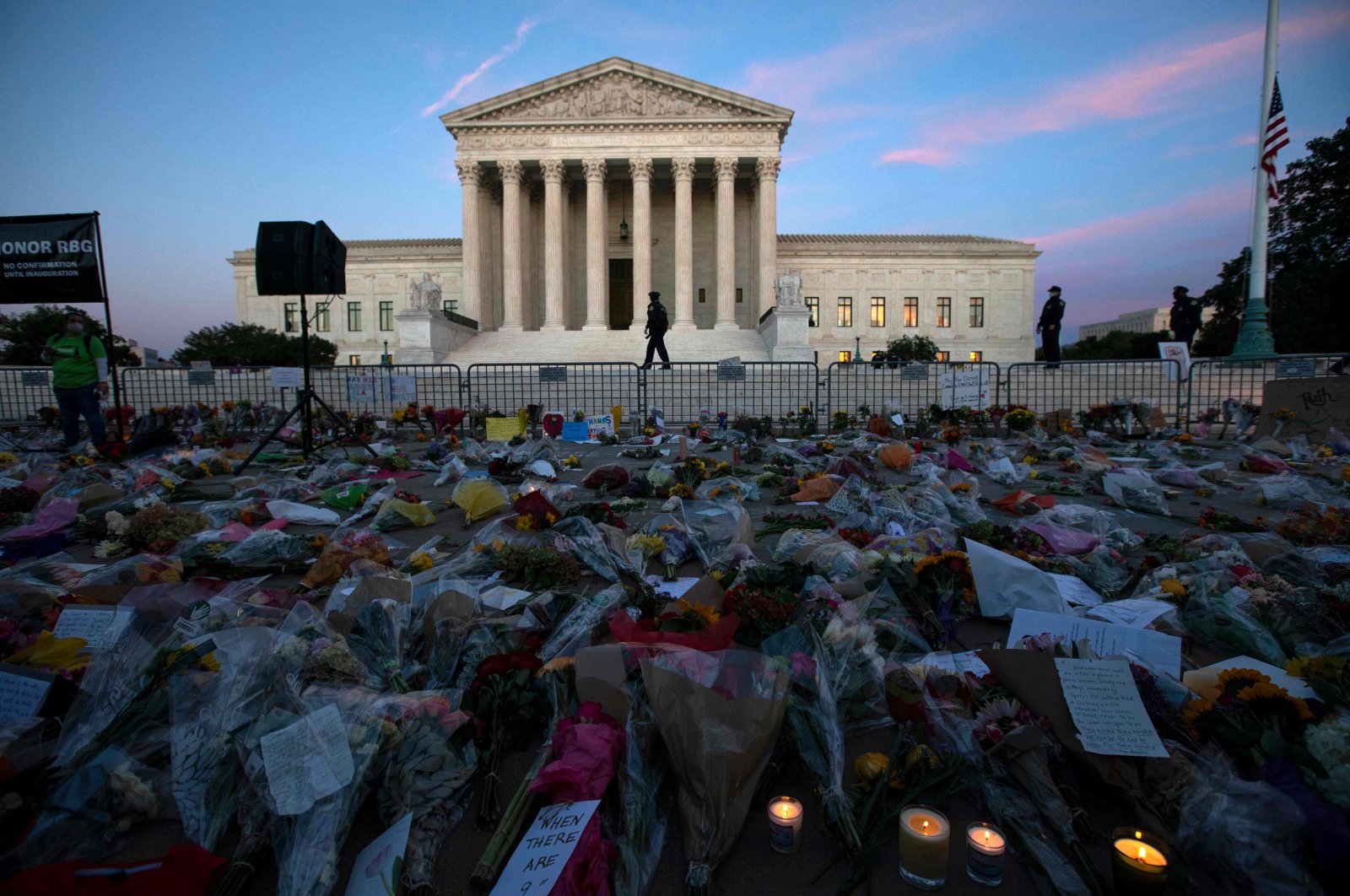 Flowers, candles and signs are pictured at a makeshift memorial outside of the U.S. Supreme Court as people pay their respects to Ruth Bader Ginsburg, Washington, D.C., Sept. 19, 2020. (AFP Photo)