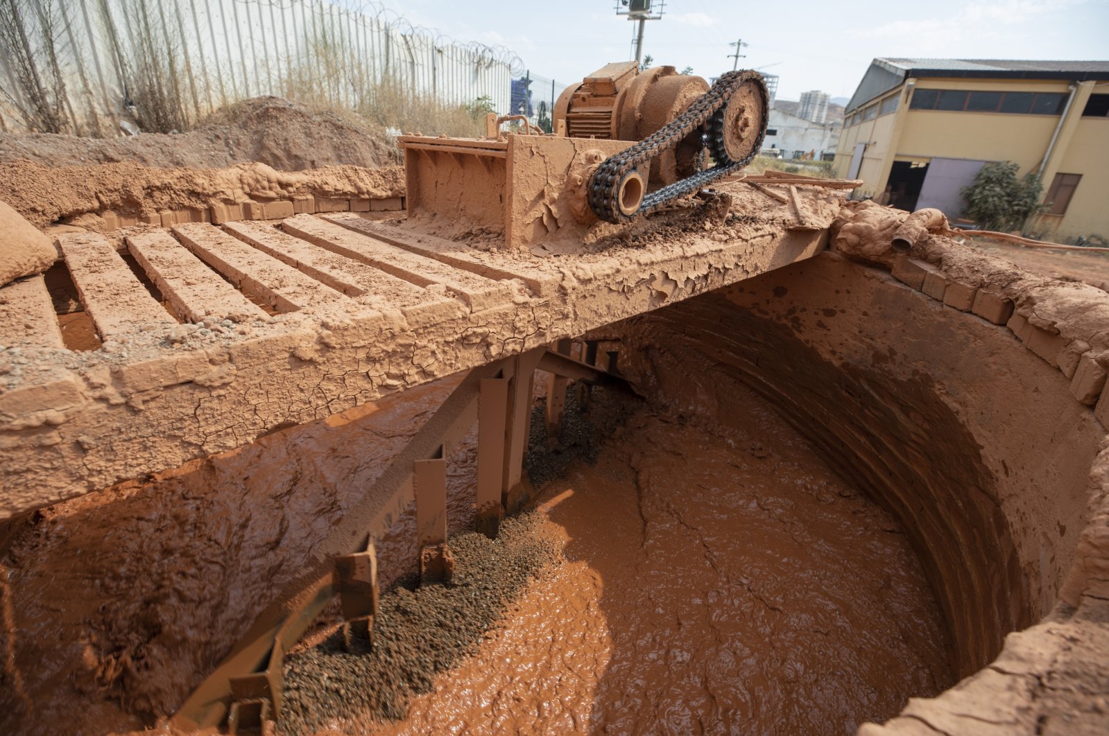 Soil brought from the countryside for use in pottery production is first processed in the large mixer at the factory to separate out stones in the Menemen district, where approximately 30 companies operate in pottery production, Izmir province, western Turkey.