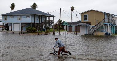 A boy rides his bike down a flooded South Magnolia Street in Rockport, Texas, U.S., as Tropical Storm Beta approaches, Sept. 21, 2020. (Reuters Photo)