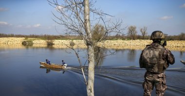 Fishermen sail along the Maritsa river as a Turkish special forces team patrols at the Turkish-Greek border near Karpuzlu village, in Edirne province, northwestern Turkey, March 11, 2020. (AP File Photo)