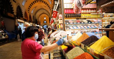 A vendor adds spice at a stall at the spice market, also known as the Egyptian Bazaar, as it reopened after weeks of closed doors amid the spread of COVID-19, Istanbul, Turkey, June 1, 2020. (Reuters Photo)
