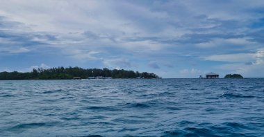 The man was found holding onto the orange box off the coast in North Maluku province, Indonesia. (Shutterstock Photo)