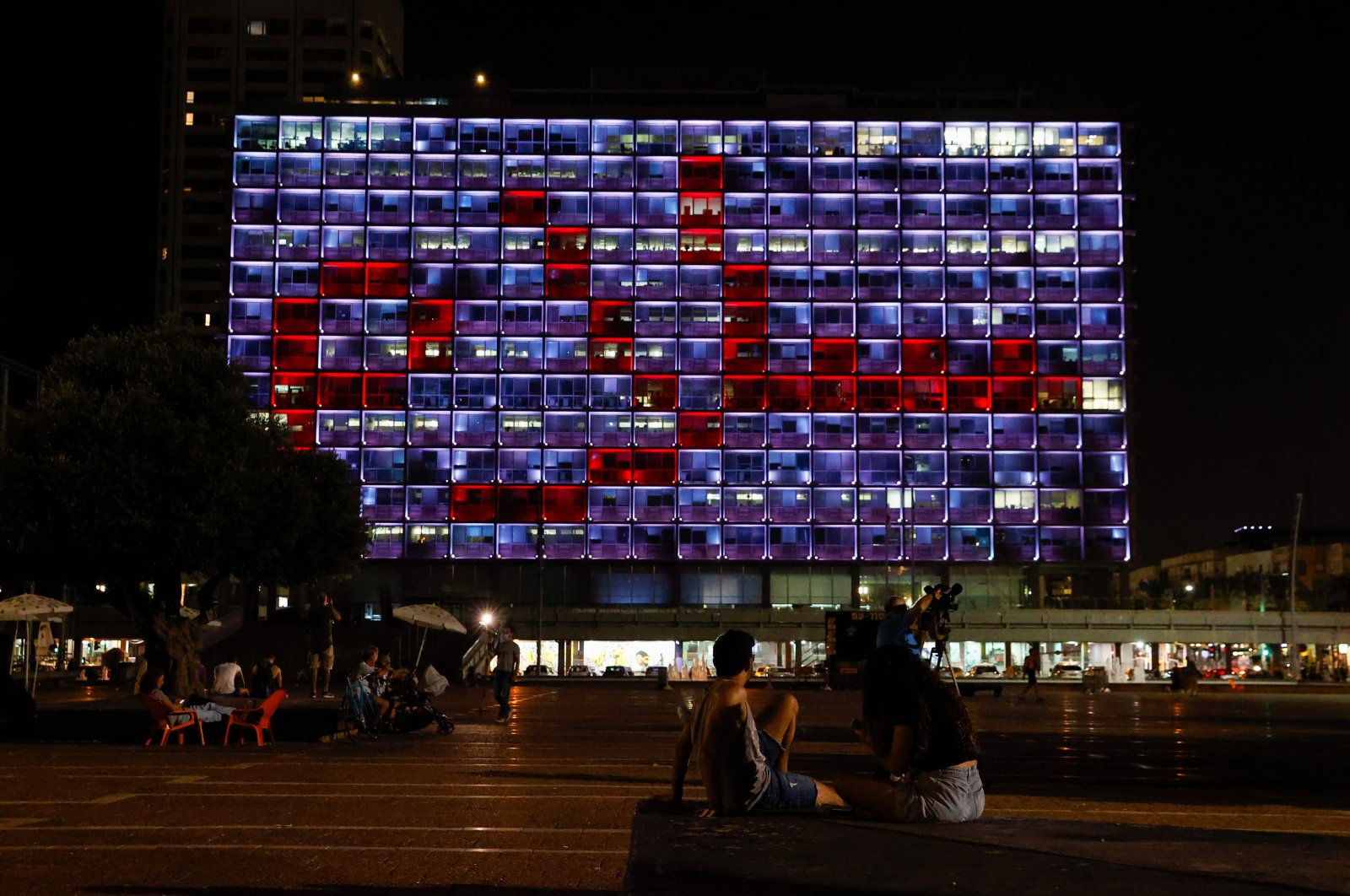 The windows of the Tel Aviv-Yafo Municipality building are illuminated with the word "peace" in Arabic, to celebrate the signing of the landmark Israeli normalization deals with the United Arab Emirates and Bahrain, Tel Aviv, Israel, Sept. 15, 2020. (AFP Photo)
