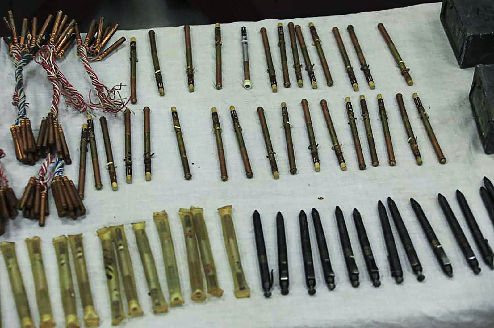 A stash of "pen guns" and sticky bombs are displayed by officials following a police forces operation, in a residential house in Kabul, Afghanistan, Sept. 19, 2020. (Afghanistan's Ministry of Interior Affairs via AFP)
