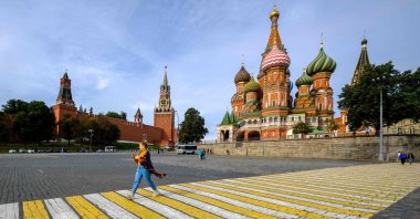 A woman walks along a crosswalk near St. Basil's Cathedral in central Moscow, Sept. 17, 2020. (AFP Photo) 