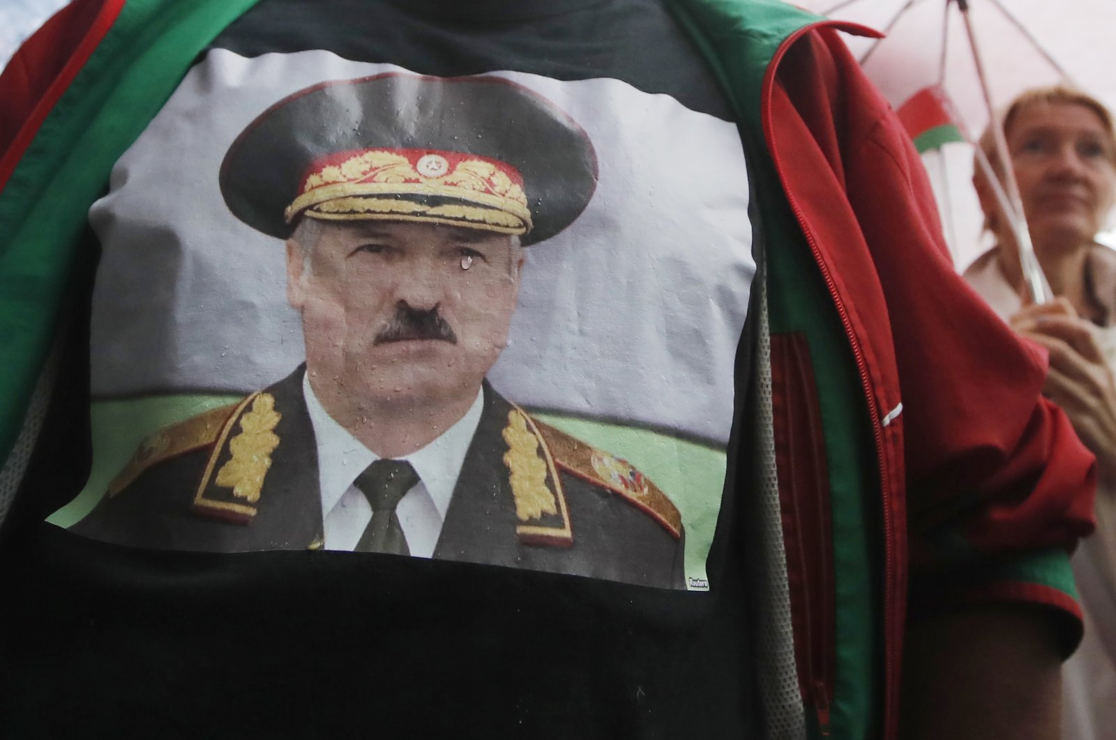 A man wearing a sweatshirt with a portrait of Belarus President Alexander Lukashenko attends a pro-government rally in Minsk, Belarus, Tuesday, Aug. 25, 2020. (AP Photo)