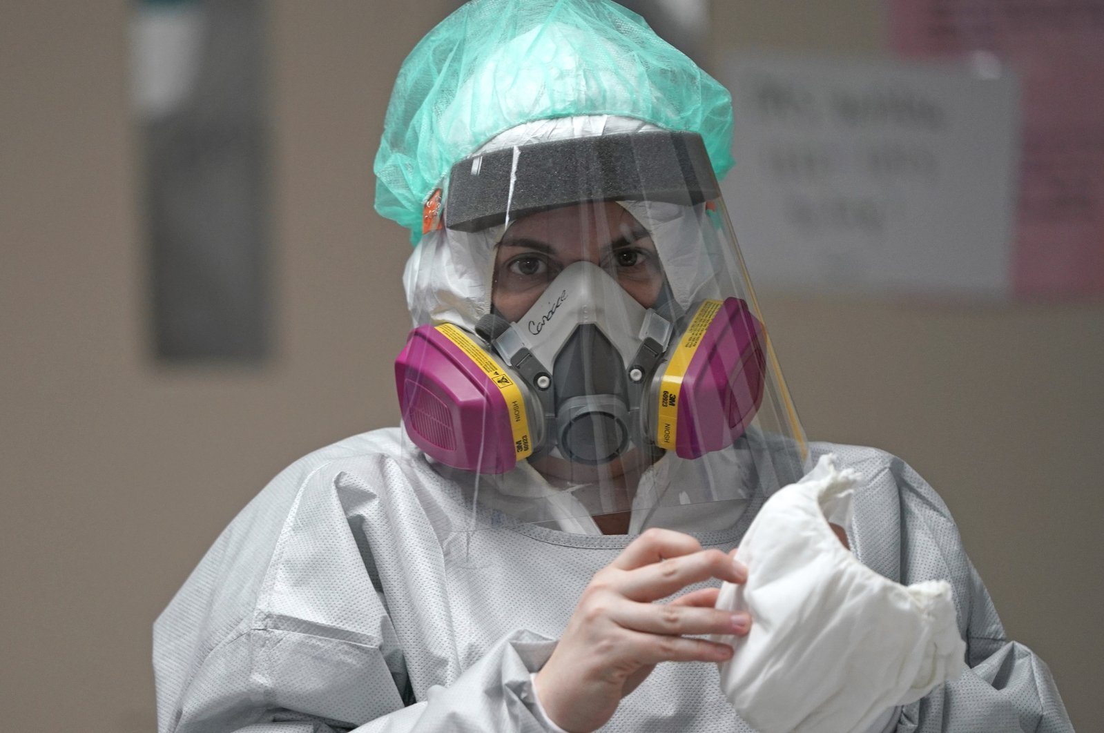 Registered nurse Candace Trammeor grabs shoe coverings inside the Coronavirus Unit at United Memorial Medical Center, Houston, Texas, U.S., July 6, 2020. (AP Photo)