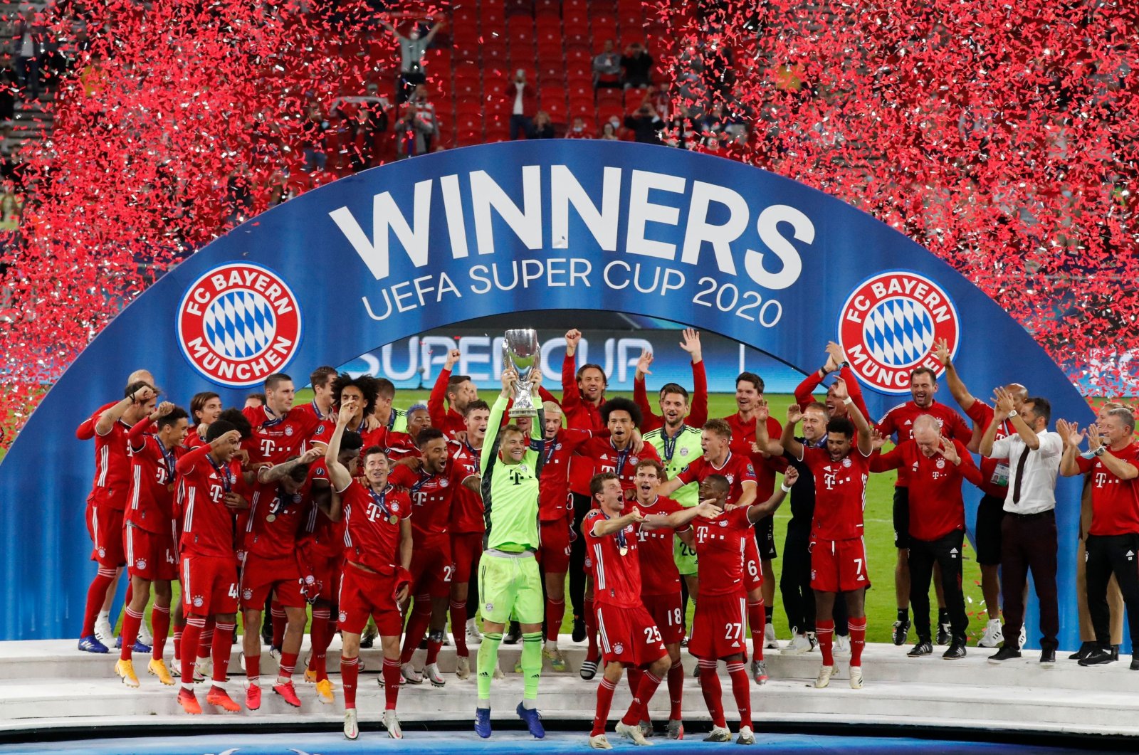 Bayern Munich's Manuel Neuer lifts the trophy with his teammates as they celebrate after winning the UEFA Super Cup match against Sevilla, in Budapest, Hungary, Sept. 24, 2020. (AFP Photo)