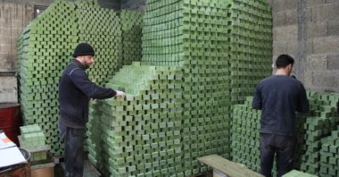 Workers stack bars of soap at the workshop of Syrian entrepreneurs in Nizip, Gaziantep, March 15, 2019.
