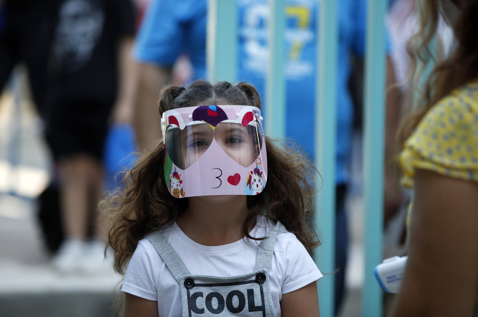 A student wearing a face mask arrives at a primary school for the start of the new school year in Athens, Greece, Sept. 14, 2020. (AP Photo)