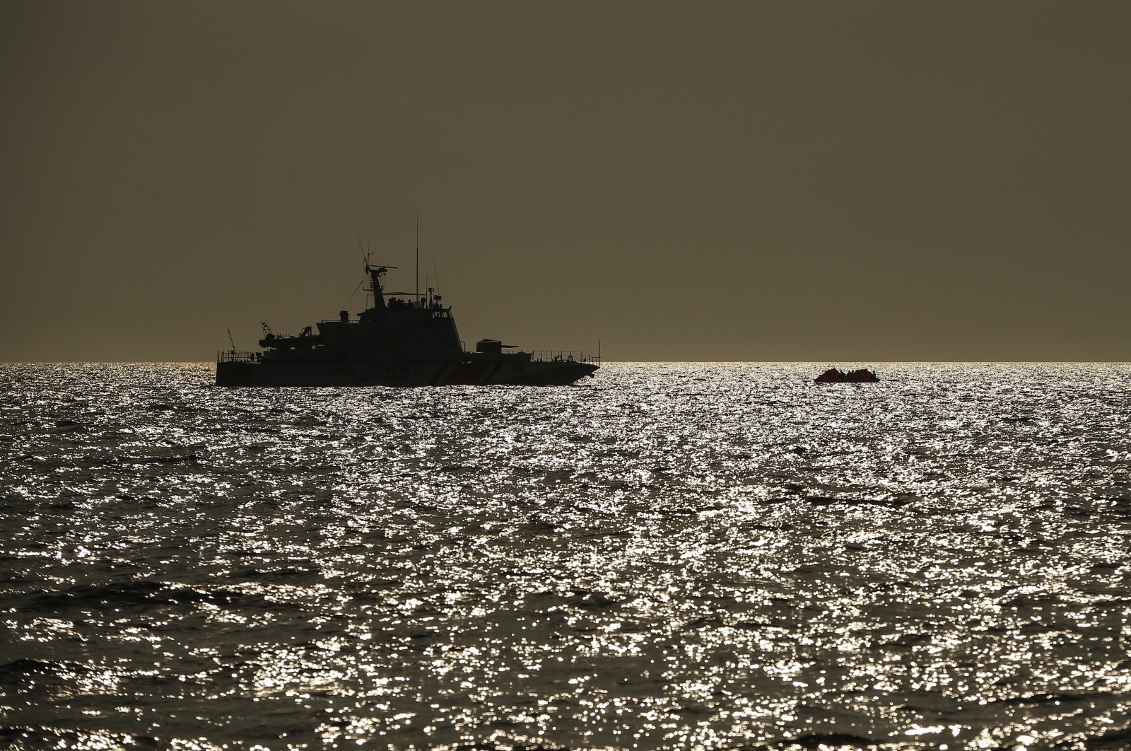 A Turkish Coast Guard vessel approaches a life raft carrying migrants in the Aegean Sea, between Turkey and Greece, Sept. 12, 2020. (AP Photo)