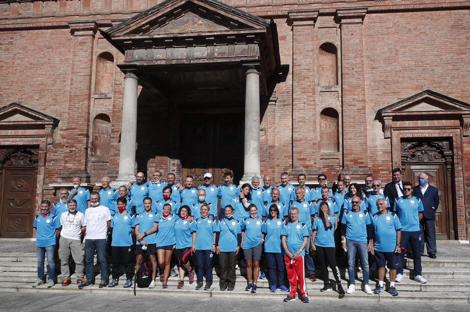 Runners pose prior to the start of a 180-kilometer relay race, in Codogno, Italy, Saturday, Sept. 26, 2020.  (AP Photo)