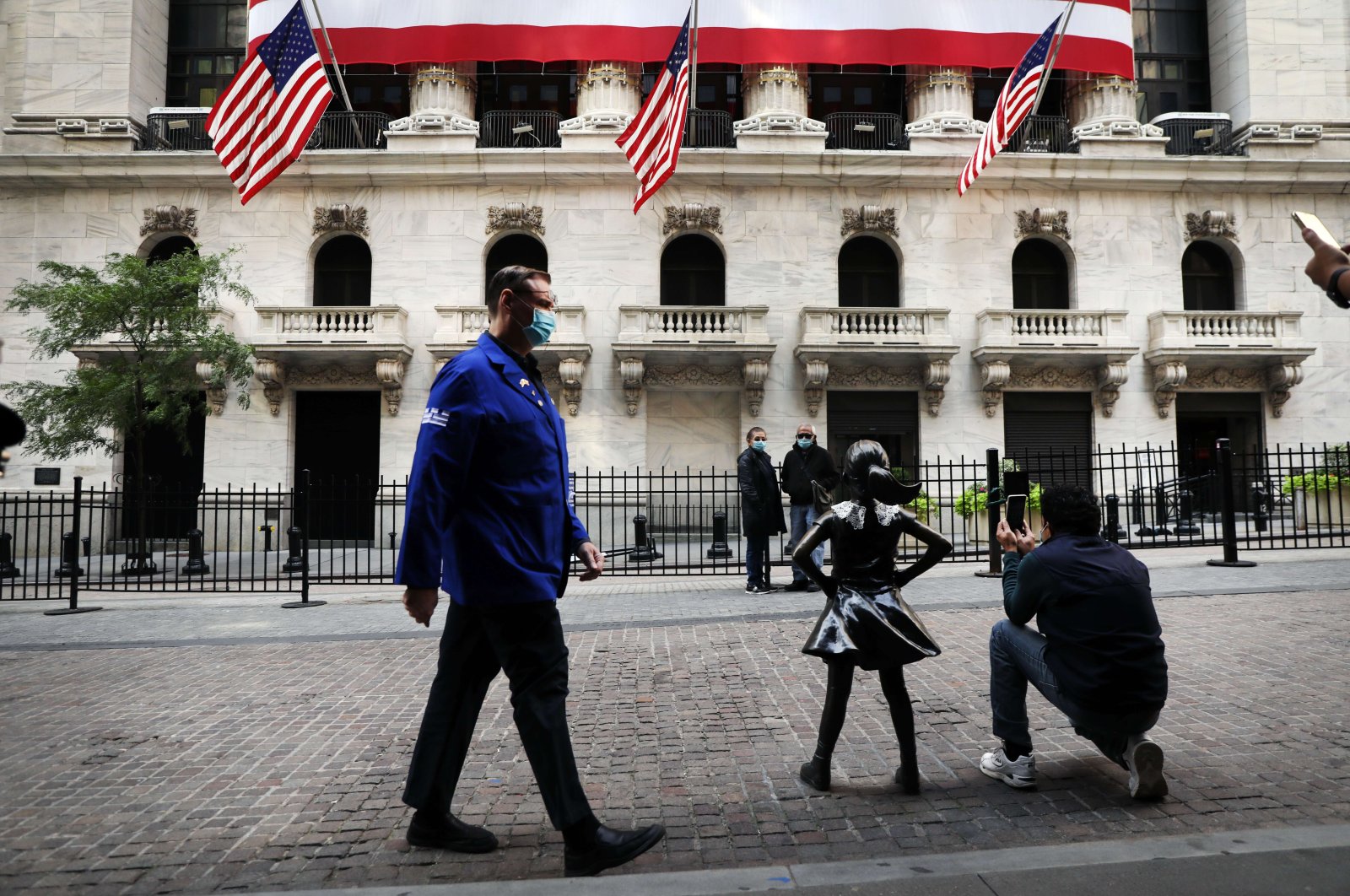 People walk in front of the New York Stock Exchange (NYSE) in lower Manhattan, New York City, Sept. 21, 2020. (AFP Photo)