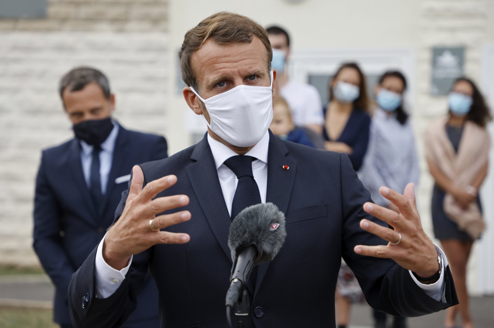 French President Emmanuel Macron speaks in Longjumeau, a southern suburb of Paris, Sept. 23, 2020. (AP Photo)