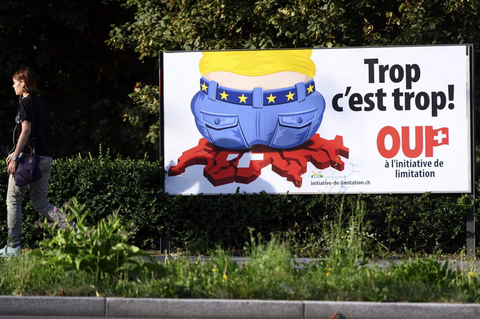A poster of the Swiss People's Party (SVP) for a moderate immigration initiative reading ''Enough is enough!'' is displayed in a street in Lausanne, Switzerland, Aug. 27, 2020. (AP File Photo)