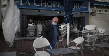 A man closes his restaurant in Marseille, southern France, Sept. 27, 2020. (AP Photo)