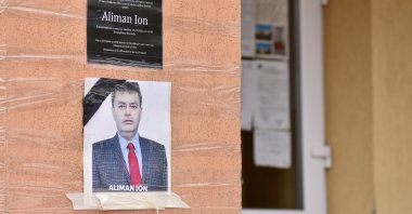 An obituary photo of former mayor Aliman Ion is taped onto the walls of the city hall in Deveselu, Romania, Sept. 28, 2020. (Reuters Photo)
