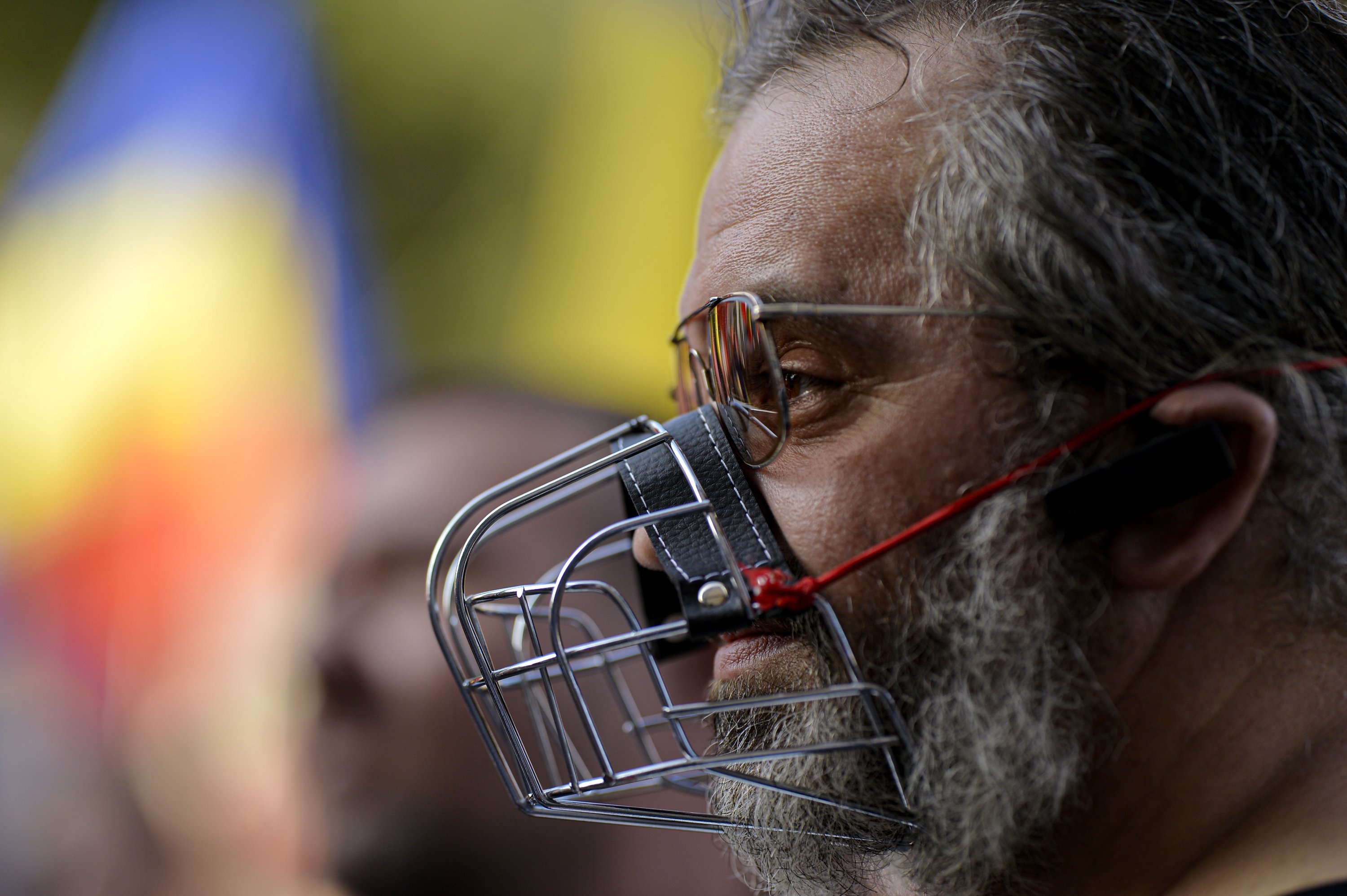 A man wears a muzzle during a protest in Bucharest, Romania, Saturday, Sept. 19, 2020. (AP Photo)
