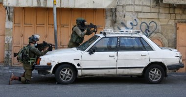 Israeli security forces aim their weapons amid clashes with Palestinian protesters in the Israeli-occupied West Bank town of Hebron, Sept. 25, 2020. (AFP Photo)