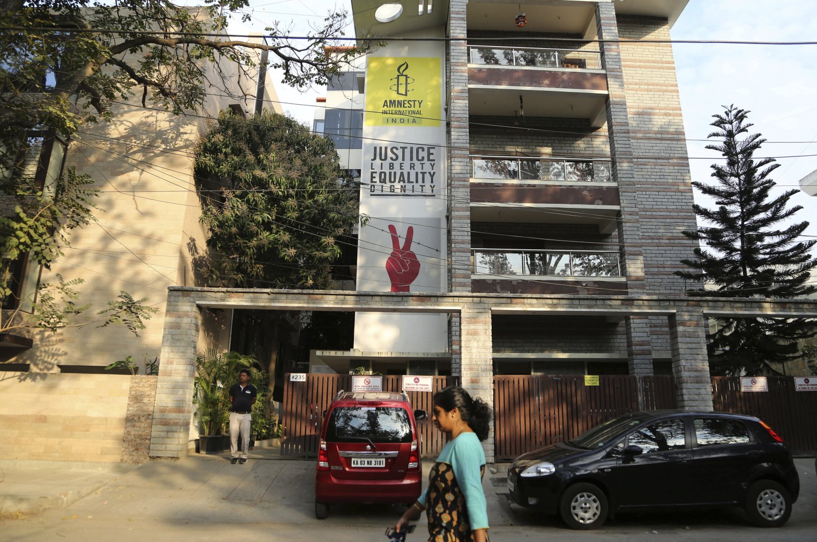In this file photo, a woman walks past the Amnesty International India headquarters in Bangalore, India, Feb. 5, 2019. (AP Photo)