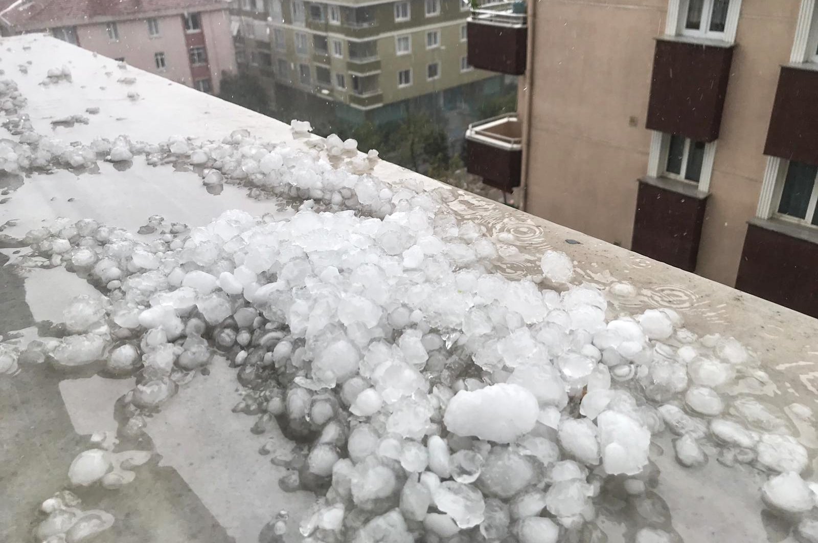 A cluster of hail pellets atop the roof of a building in Üsküdar district, in Istanbul, Turkey, Sept. 29, 2020. (AA Photo)