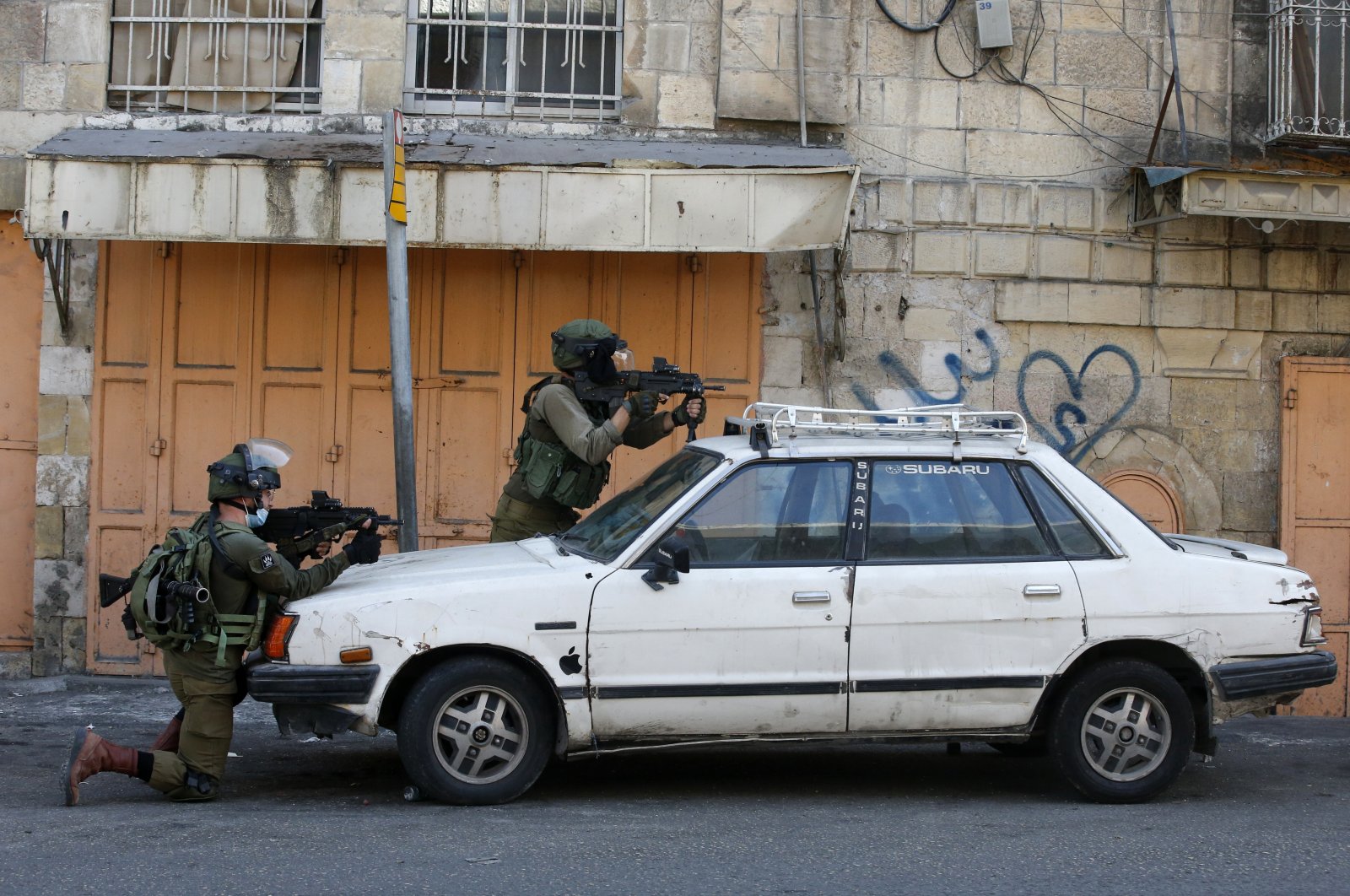 Israeli security forces aim their weapons amid clashes with Palestinian protesters in the Israeli-occupied West Bank town of Hebron, Sept. 25, 2020. (AFP Photo)