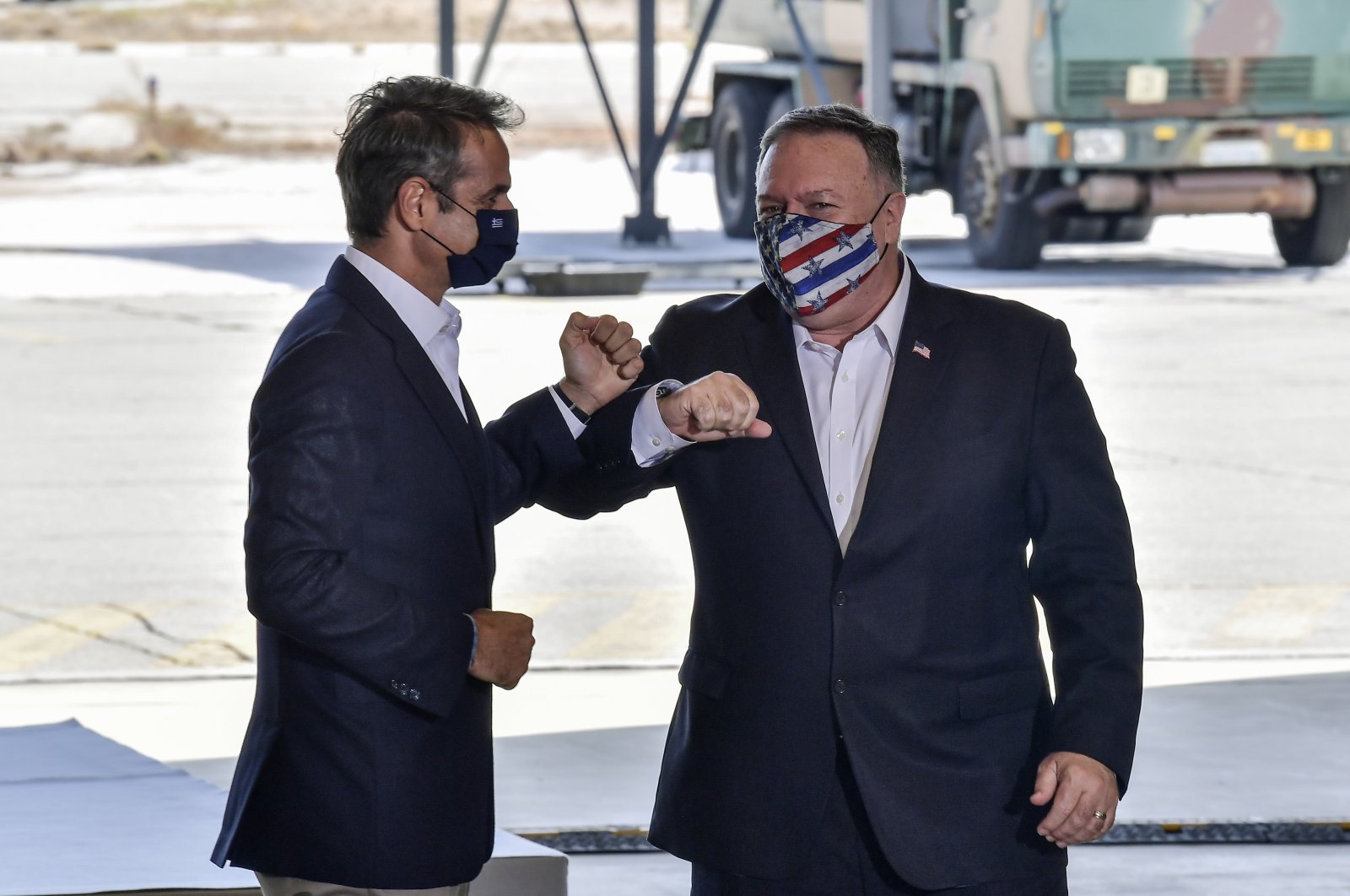 U.S. Secretary of State Mike Pompeo, right, and Greek Prime Minister Kyriakos Mitsotakis pose during their visit at the Naval Support Activity base at Souda, on the Greek island of Crete, Tuesday, Sept. 29, 2020. (AP Photo)