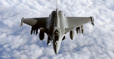 A French Rafale fighter jet from the Istres military air base approaches an airborne Boeing C-135 refueling tanker aircraft (not pictured) on March 30, 2011. (AFP Photo)