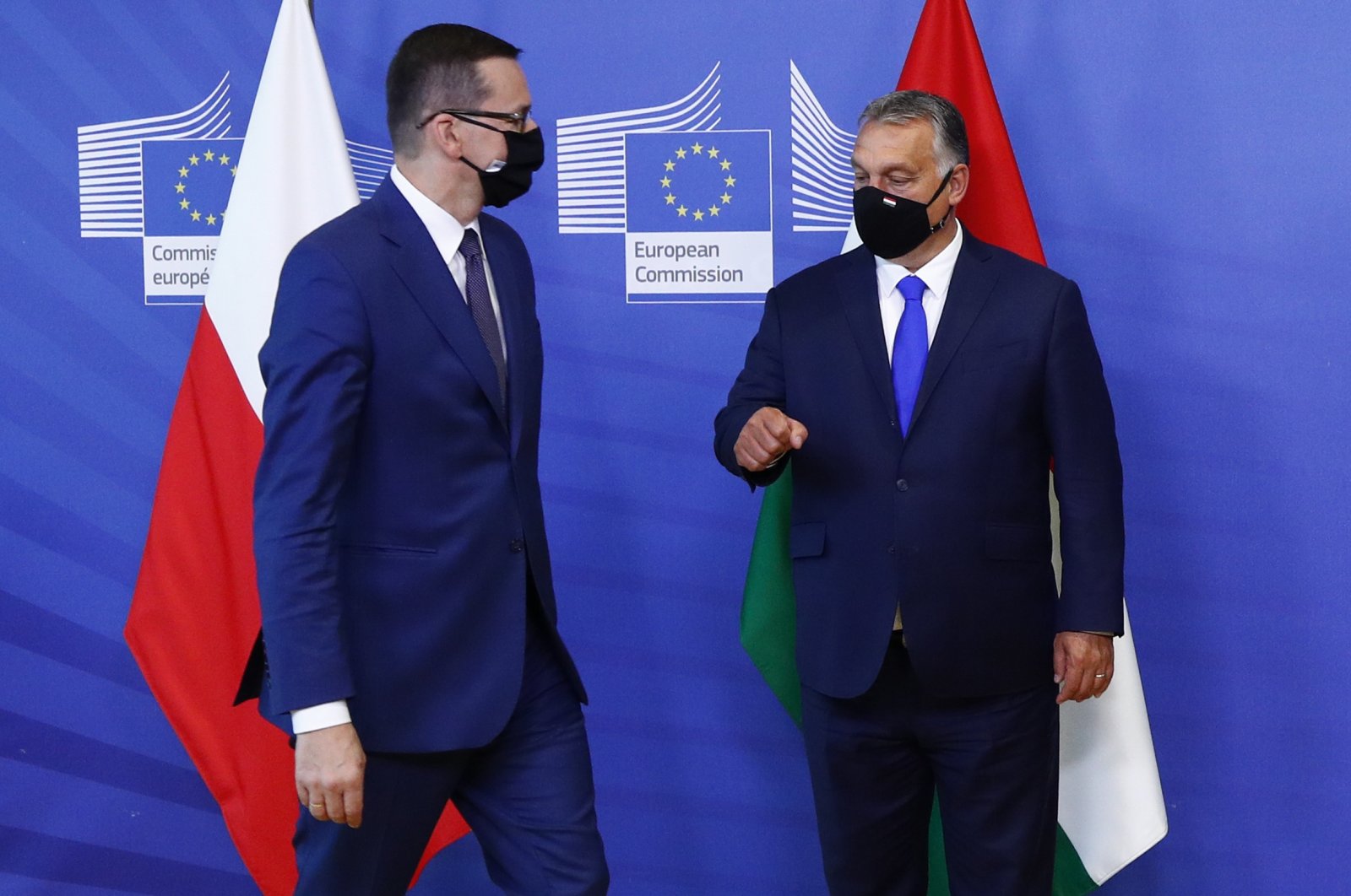 Poland's Prime Minister Mateusz Morawiecki (L) speaks with Hungary's Prime Minister Viktor Orban prior to a meeting with European Commission President Ursula von der Leyen, not pictured, and the Visegrad Group at EU headquarters in Brussels, Sept 24, 2020. (Pool via AP)