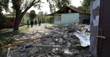People look at a house destroyed by Armenian shelling in the city of Tartar, Azerbaijan, Sept. 29, 2020. (EPA Photo)