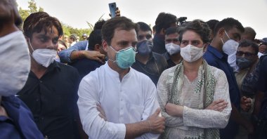 India’s opposition Congress party leaders, Rahul Gandhi (C) and his sister Priyanka Gandhi (R) stand after they were stopped by police on a highway in Gautam Buddha Nagar, Uttar Pradesh state, India, Oct. 1, 2020. (AP Photo)