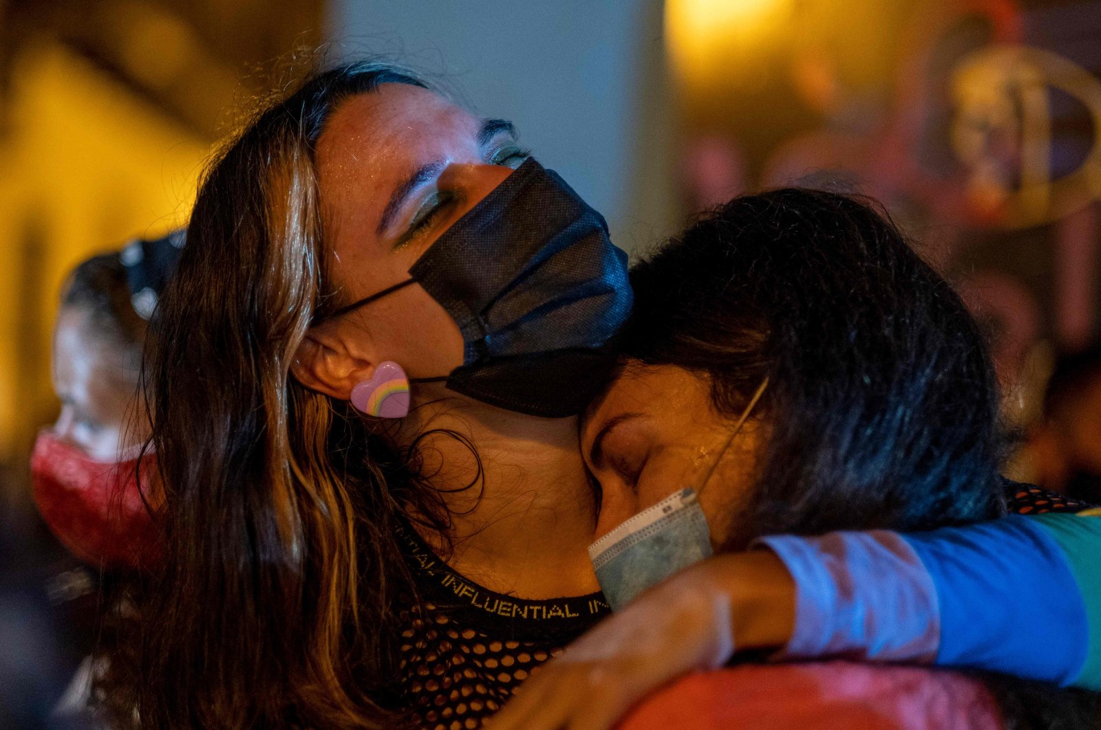 Two women hug as people led by activist group Feminist Collective protest to demand Gov. Wanda Vazquez declare a state of emergency in response to recent gender-based femicides, assaults and disappearances in San Juan, Puerto Rico, Sept. 28, 2020. (AFP Photo)