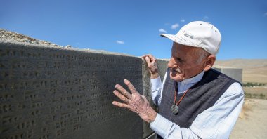 Mehmet Kuşman shows an Urartian inscription at Çavuştepe Castle, in Van, eastern Turkey, Oct.1, 2020. (AA Photo)