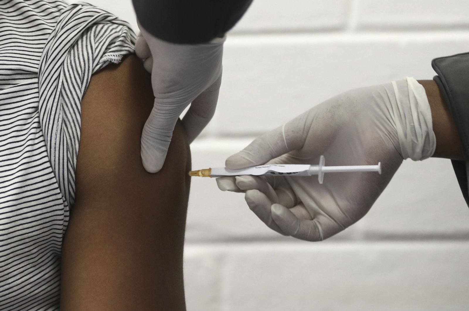 A volunteer receives an injection at the Chris Hani Baragwanath hospital in Soweto, Johannesburg on Wednesday, June 24, 2020. (AP Photo)