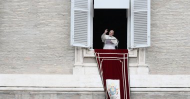 Pope Francis waves to worshippers from the window of the Apostolic palace overlooking St. Peter's Square during the weekly Angelus prayer in the Vatican, Oct. 4, 2020. (AFP Photo)