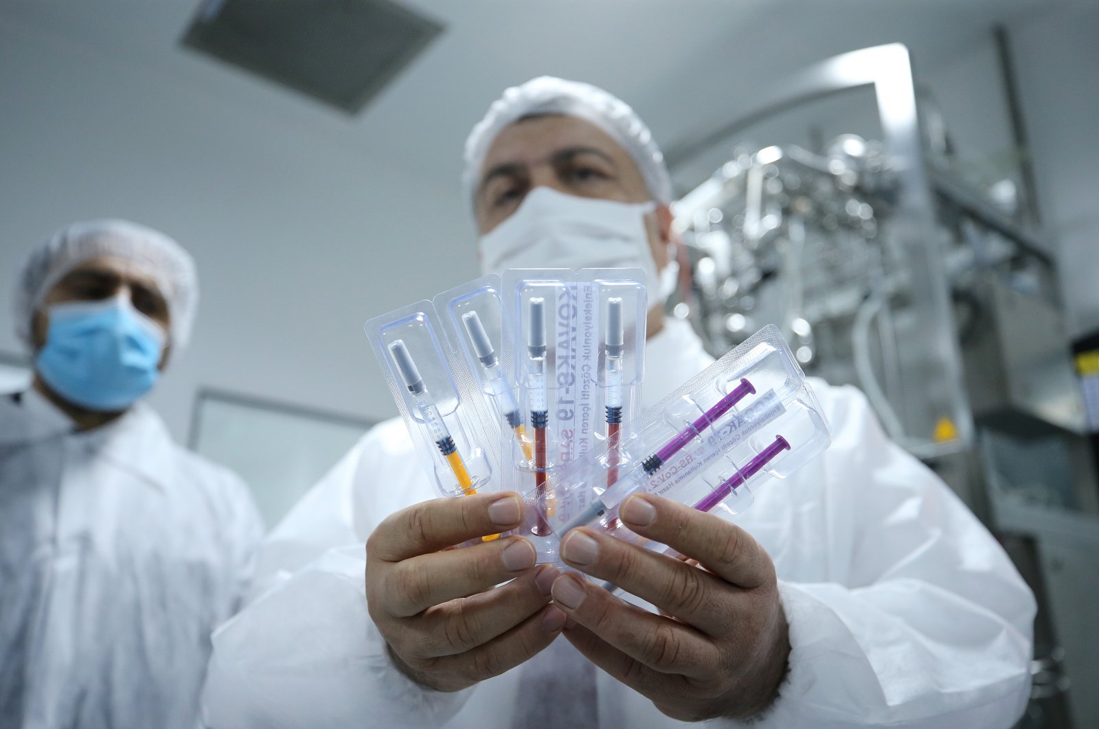 Health Minister Fahrettin Koca holds COVID-19 vaccine samples in a pharmaceutical factory in Tekirdağ, Turkey, Oct. 3, 2020. (AA Photo)
