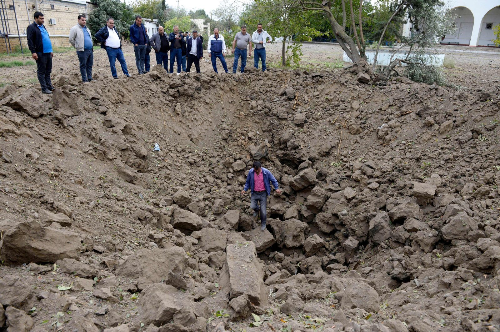 A man inspects a crater caused by an Armenian rocket strike in the town of Beylagan during the ongoing fighting between Armenia and Azerbaijan over the Nagorno-Karabakh region, Oct. 4, 2020. (AFP File Photo)