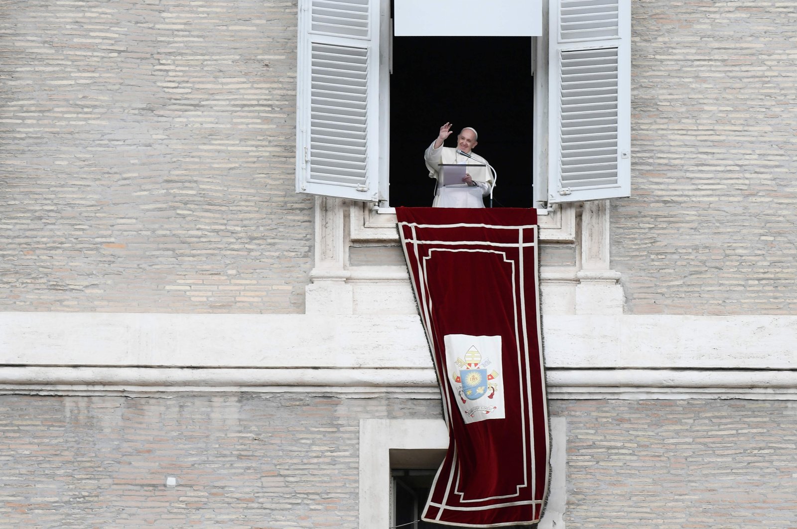 Pope Francis waves to worshippers from the window of the Apostolic palace overlooking St. Peter's Square during the weekly Angelus prayer in the Vatican, Oct. 4, 2020. (AFP Photo)