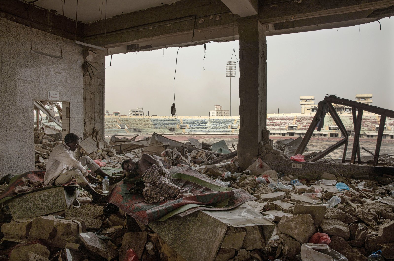 Ethiopian migrants take shelter in the "22nd May Soccer Stadium," destroyed by war, in Aden, Yemen, July 21, 2019. (AP Photo)