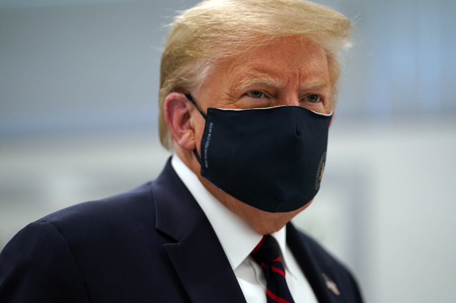 In this July 27, 2020, file photo, President Donald Trump wears a face mask as he participates in a tour of Bioprocess Innovation Center at Fujifilm Diosynth Biotechnologies in Morrisville, N.C. President Donald Trump and first lady Melania Trump have tested positive for the coronavirus, the president tweeted early Friday. (AP Photo)