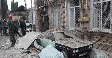 Emergency personnel work in a damaged area of the Azerbaijani city of Ganja following an Armenian rocket strike on Oct. 4, 2020. (AFP Photo)