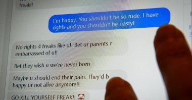 An exchange of abusive messages is seen on a laptop screen in Bristol in this undated photo. (PA via REUTERS)