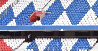 A staff member is seen in the empty stands prior to a Bundesliga football match between FC Bayern Munich and Hertha Berlin at Allianz Arena in Munich, Germany, Oct. 4, 2020. (AFP Photo)