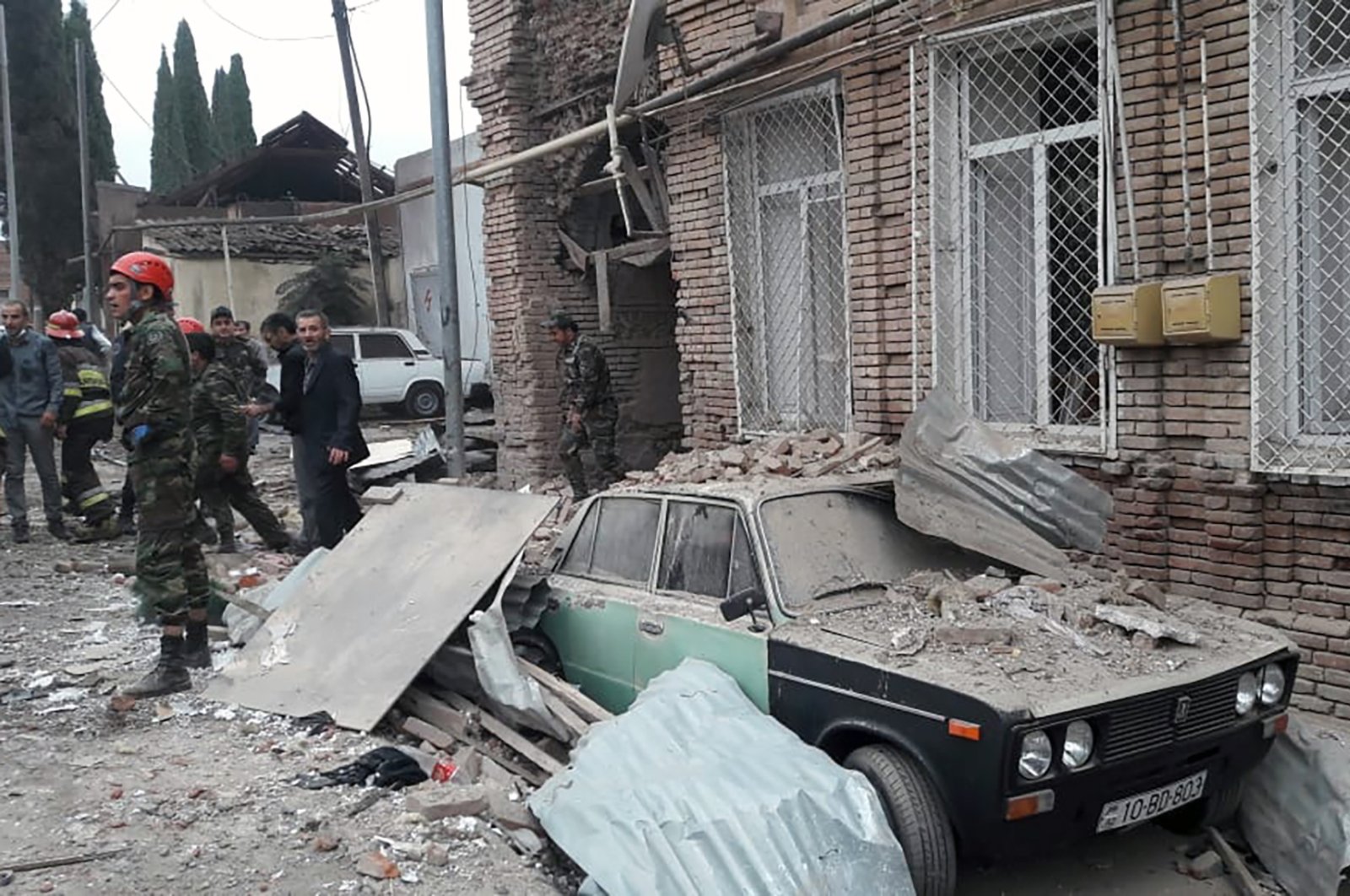 Emergency personnel work in a damaged area of the Azerbaijani city of Ganja following an Armenian rocket strike on Oct. 4, 2020. (AFP Photo)