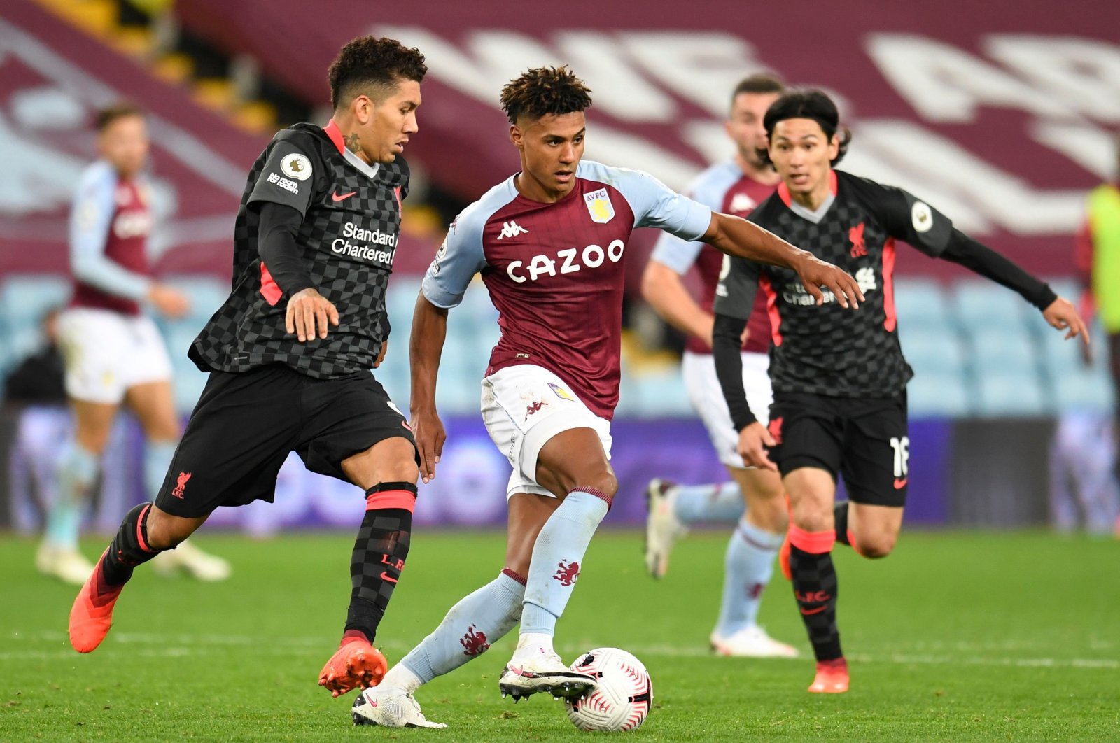 Aston Villa's Ollie Watkins (C) tries to dribble past Liverpool's Roberto Firmino (L) and Takumi Minamino during a Premier League match, in Birmingham, Britain, Oct. 4, 2020. (Reuters Photo)