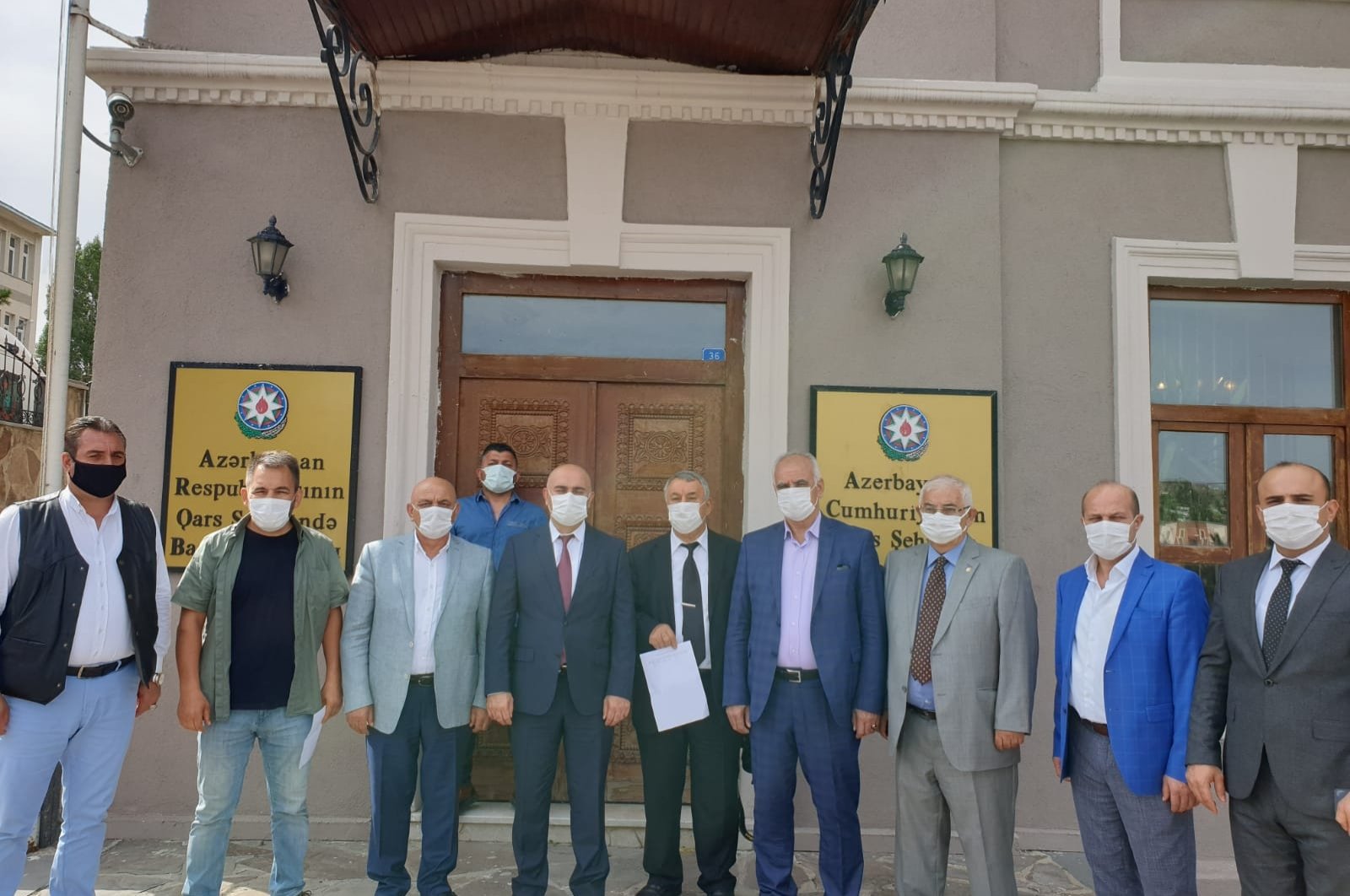 Representatives of several Turkish NGOs pose in front of the consulate-general of Azerbaijan in Kars after volunteering to fight alongside Azerbaijani forces, Kars, Oct. 4, 2020. (DHA)